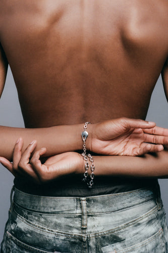 Kabocha Bracelet in 925 silver on crossed wrists behind the back, layered with the FF Bracelet.