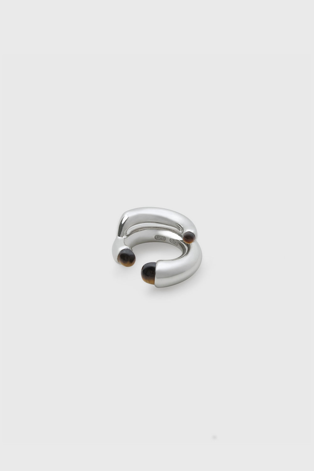 INO sterling silver double-band ear cuff with tiger's eye stone caps at each tip, stacked arc form, INO 925 stamp visible, white background