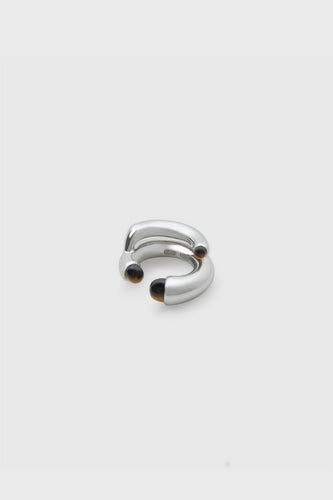 INO sterling silver double-band ear cuff with tiger's eye stone caps at each tip, stacked arc form, INO 925 stamp visible, white background