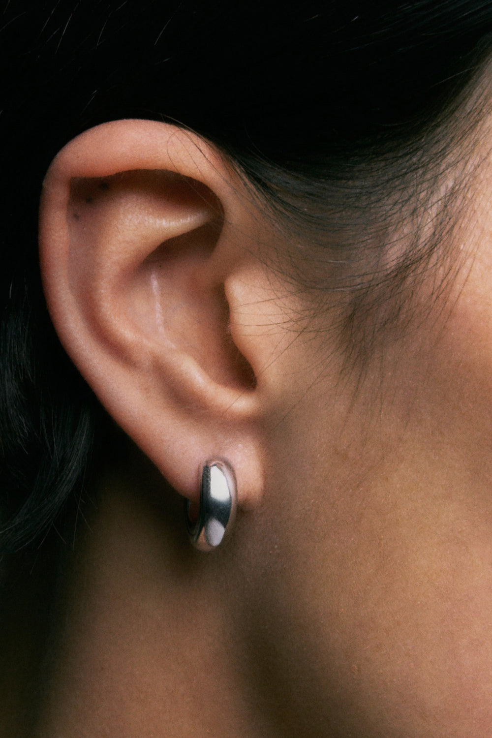 Onion Earrings in 925 silver, close view of the domed hoop on the ear.