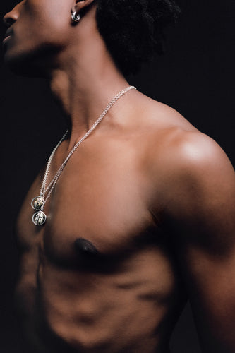 Quail Egg Necklace in 925 silver, two pendants layered on fine chains against a dark ground.