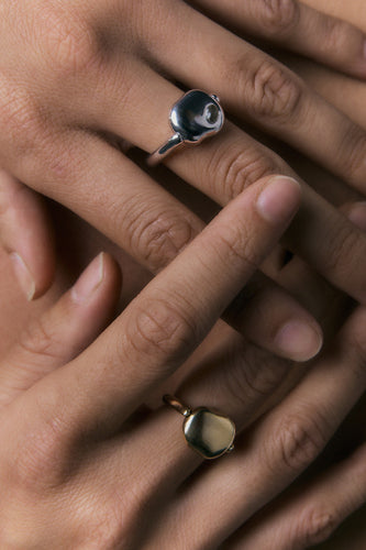 FF Swivel Ring shown in 925 silver and 14k gold on two hands, close view of the pebble face.