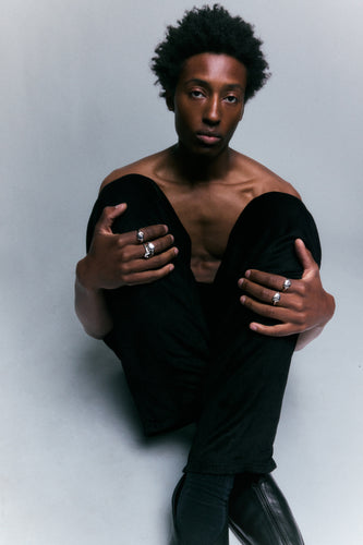FF Swivel Ring in 925 silver worn on both hands, seated full-length portrait.