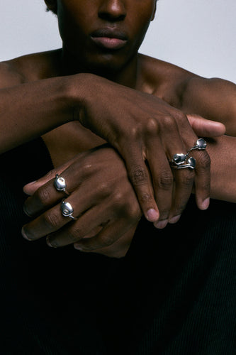FF Swivel Ring in 925 silver, several worn across crossed hands.