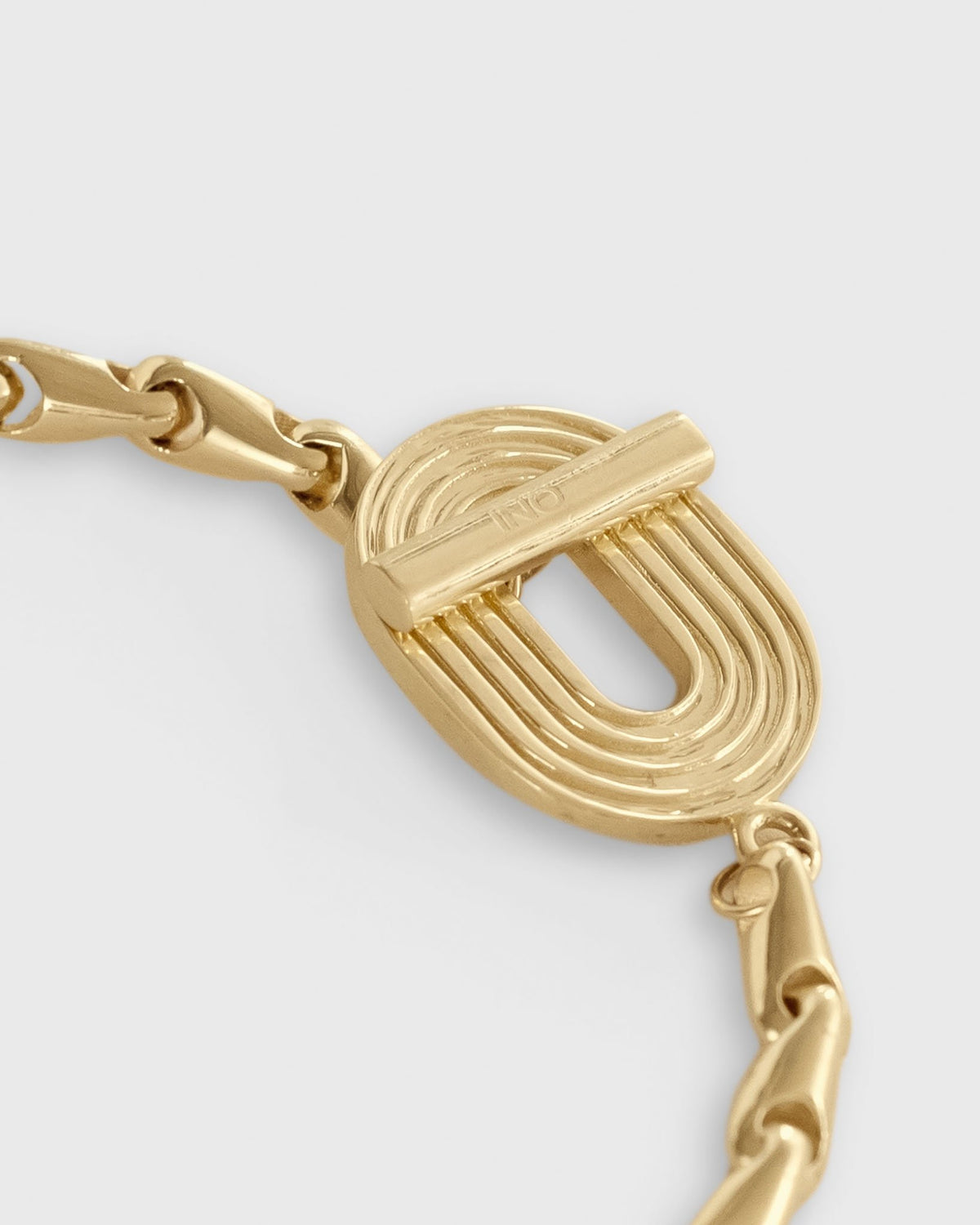 close up of eight bracelet in solid 14k yellow gold