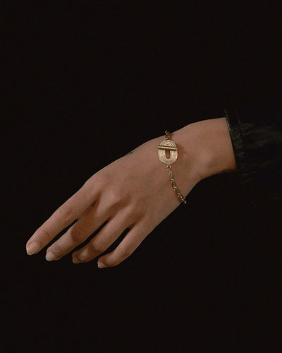 model wearing eight bracelet in solid 14k yellow gold
