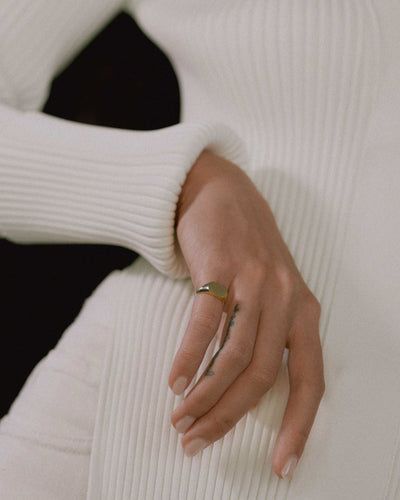 model wearing cushion signet ring in solid 14k yellow gold