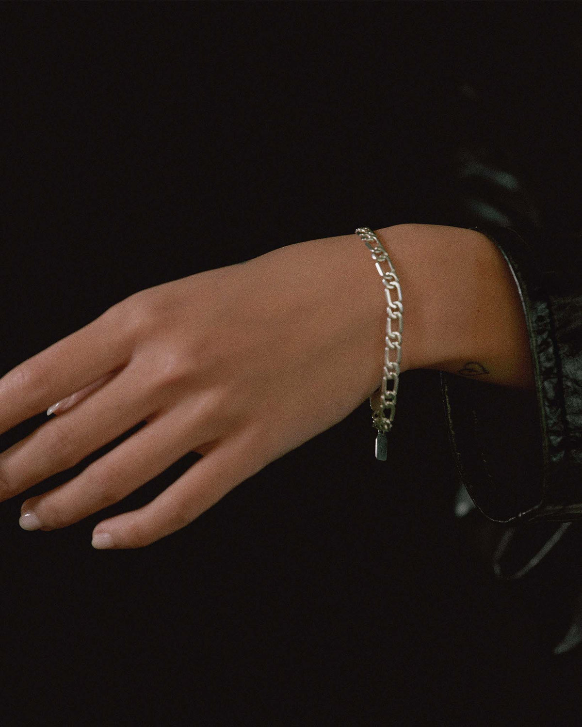 model wearing figaro bracelet in solid 925 sterling silver